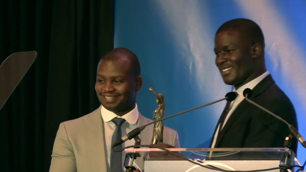 UN Ambassador Victor Ochen presents Aegis Regional Director Freddy Mutanguha with the inaugural Peace, Justice and Security Award in the Hague, 5 Sept 2016